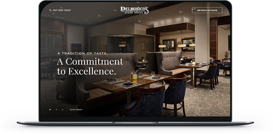 Laptop screen showing Delmonico's restaurant website